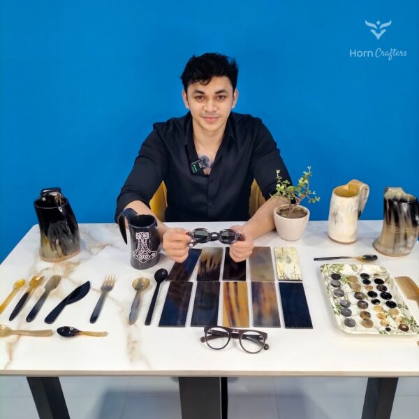 Horn Crafters team member sitting next to horn handicrafts products.