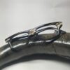 horn rimmed reading glasses kept on top of buffalo horn