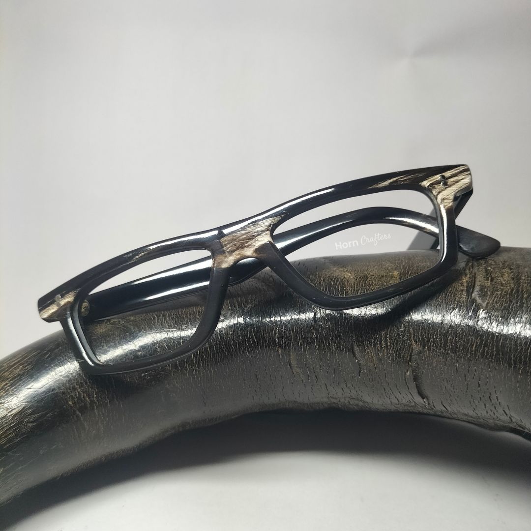 horn rimmed reading glasses kept on top of buffalo horn