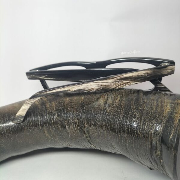 horn rimmed reading glasses kept on top of buffalo horn
