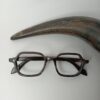 Genuine horn rimmed kids prescription glasses kept aside horn tip
